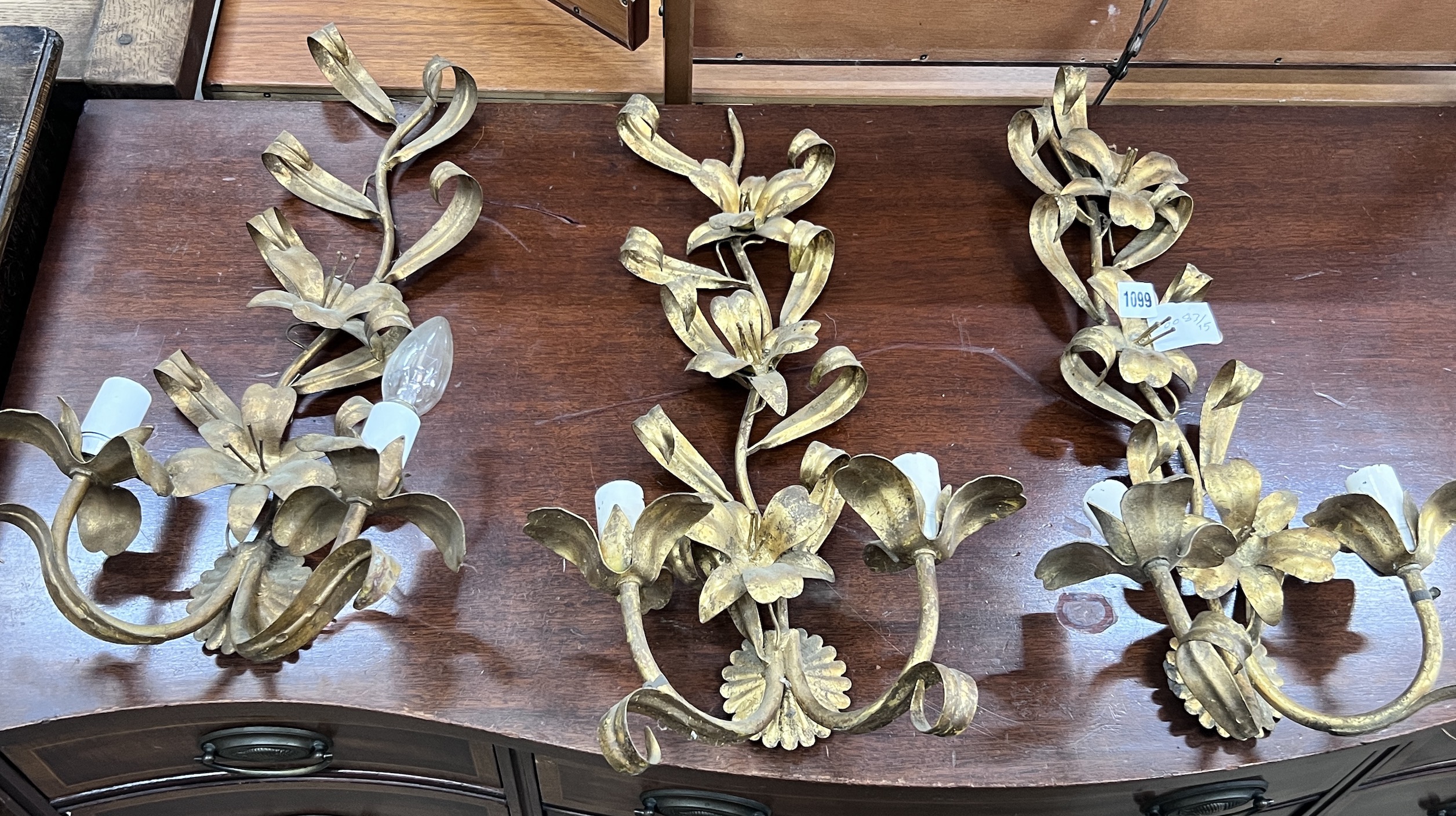 A set of three gilt metal floral two branch wall lights